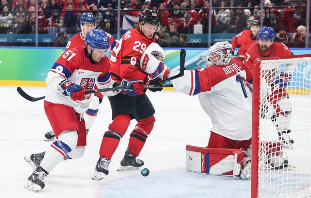 (260219) -- MILAN, Feb. 19, 2026 (Xinhua) -- Players of both teams vie for the puck during the ice hockey men's play-offs quarterfinals match between Canada and the Czech Republic at the Milan-Cortina 2026 Olympic Winter Games in Milan, Italy, Feb. 18, 2026. (Xinhua/Wang Kaiyan)