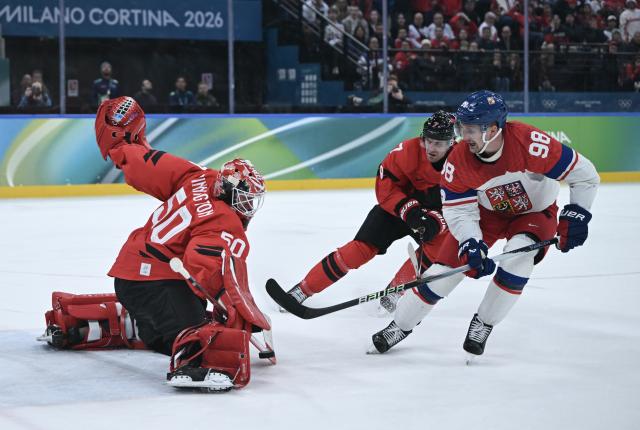 (260219) -- MILAN, Feb. 19, 2026 (Xinhua) -- Martin Necas (R) of the Czech Republic shoots during the ice hockey men's play-offs quarterfinals match between Canada and the Czech Republic at the Milan-Cortina 2026 Olympic Winter Games in Milan, Italy, Feb. 18, 2026. (Xinhua/Zhang Haofu)