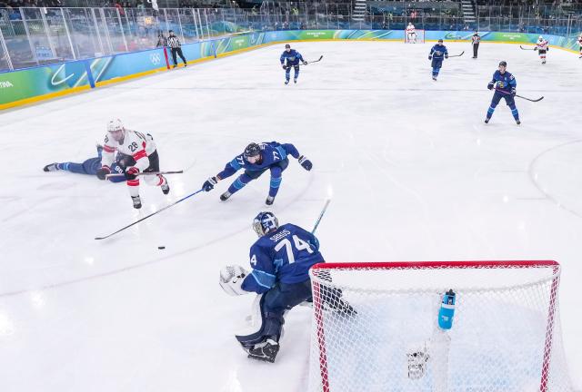(260219) -- MILAN, Feb. 19, 2026 (Xinhua) -- Niko Mikkola (3rd L) of Finland fights for the puck against Timo Meier (2nd L) of Switzerland during the ice hockey men's play-offs quarterfinal between Finland and Switzerland at the Milan-Cortina 2026 Olympic Winter Games in Milan, Italy, Feb. 18, 2026. (Xinhua/Sun Fei)