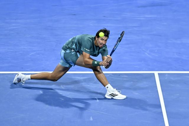 (260219) -- DOHA, Feb. 19, 2026 (Xinhua) -- Alexei Popyrin of Australia hits a return during the men's singles round of 16 match between Jannik Sinner of Italy and Alexei Popyrin of Australia at the ATP Qatar Open 2026 tennis tournament in Doha, Qatar, on Feb. 18, 2026. (Photo by Nikku/Xinhua)