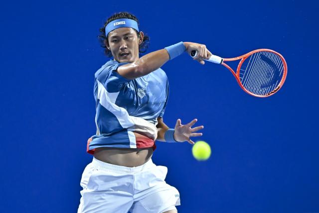 (260219) -- DOHA, Feb. 19, 2026 (Xinhua) -- Zhang Zhizhen of China hits a return during the men's singles round of 16 match between Zhang Zhizhen of China and Jakub Mensik of the Czech Republic at the ATP Qatar Open 2026 tennis tournament in Doha, Qatar, on Feb. 18, 2026. (Photo by Nikku/Xinhua)