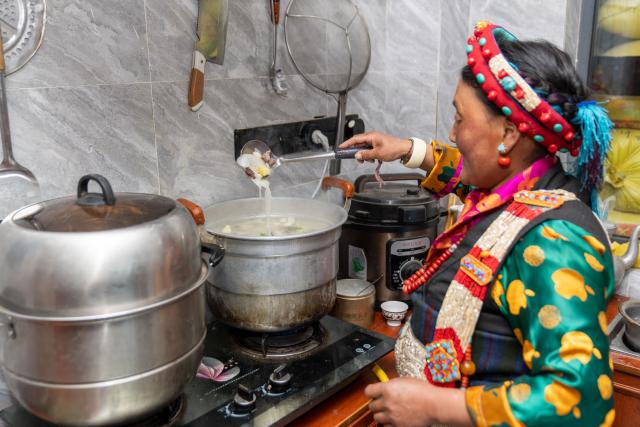 (260219) -- LHASA, Feb. 19, 2026 (Xinhua) -- Drolma Tsering makes "gutu," a kind of soup made of flour, at home in Gurum Village of Chamco Township, Dingri County, southwest China's Xizang Autonomous Region, Feb. 16, 2026.  "Gu" in Tibetan means nine and "Tu" means pasta. At the Night of Gutu, the whole family and relatives gather to enjoy the dish and celebrate the occasion.
  Monday was the Chinese New Year's Eve, which coincided with the Night of Gutu of the Tibetan calendar. Enjoying the festive atmosphere, the family of Sangs-rgyas purchased new furniture and stocked up on New Year goods, celebrating their first Spring Festival and Tibetan New Year after moving into their new house.
  Last year, a 6.8 magnitude earthquake hit Dingri, home to the northern base camp of the world's highest peak, Mount Qomolangma, and other counties in the region on Jan. 7. In less than three days after the earthquake, Xizang rolled out a post-disaster reconstruction plan and kicked off the reconstruction work later. In the second half of 2025, the family of Sangs-rgyas moved into a safe and comfortable new residence. (Xinhua/Tenzing Nima Qadhup)