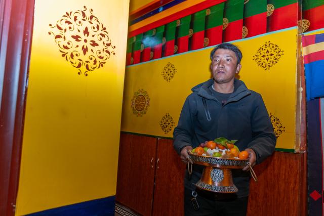 (260219) -- LHASA, Feb. 19, 2026 (Xinhua) -- Sangs-rgyas prepares fruits for new year celebration at home in Gurum Village of Chamco Township, Dingri County, southwest China's Xizang Autonomous Region, Feb. 16, 2026.
  Monday was the Chinese New Year's Eve, which coincided with the Night of Gutu of the Tibetan calendar. Enjoying the festive atmosphere, the family of Sangs-rgyas purchased new furniture and stocked up on New Year goods, celebrating their first Spring Festival and Tibetan New Year after moving into their new house.
  Last year, a 6.8 magnitude earthquake hit Dingri, home to the northern base camp of the world's highest peak, Mount Qomolangma, and other counties in the region on Jan. 7. In less than three days after the earthquake, Xizang rolled out a post-disaster reconstruction plan and kicked off the reconstruction work later. In the second half of 2025, the family of Sangs-rgyas moved into a safe and comfortable new residence. (Xinhua/Tenzing Nima Qadhup)