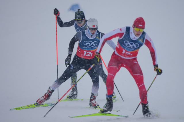 (260219) -- TESERO, Feb. 19, 2026 (Xinhua) -- Zhao Zihe (C) of China competes during the cross-country event of the nordic combined team sprint at the 2026 Milan-Cortina Winter Olympics in Tesero, Italy, Feb. 19, 2026. (Xinhua/Peng Ziyang)