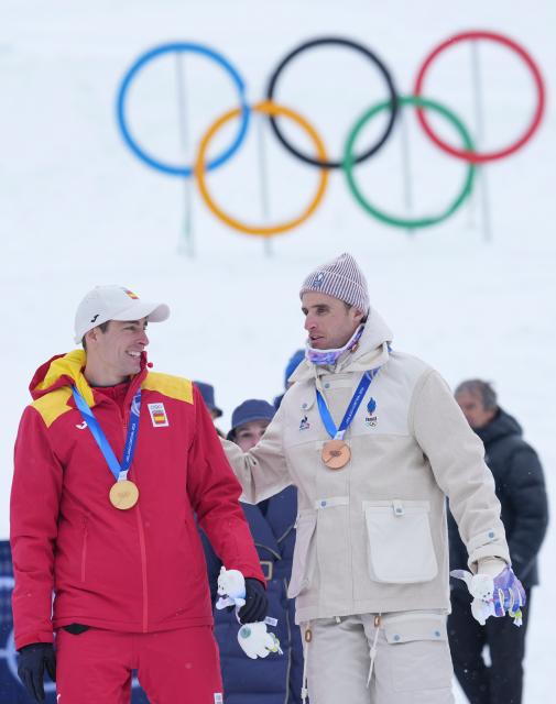 (260219) -- BORMIO, Feb. 19, 2026 (Xinhua) -- Gold medalist Oriol Cardona Coll (L) of Spain communicates with bronze medalist Thibault Anselmet of France after the awarding ceremony of the ski mountaineering men's sprint event at the Milan-Cortina 2026 Olympic Winter Games in Bormio, Italy, Feb. 19, 2026. (Xinhua/Hu Huhu)