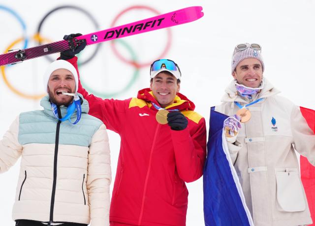 (260219) -- BORMIO, Feb. 19, 2026 (Xinhua) -- Gold medalist Oriol Cardona Coll (C) of Spain, silver medalist individual neutral athlete Nikita Filippov (L), and bronze medalist Thibault Anselmet of France pose for photos during the awarding ceremony of the ski mountaineering men's sprint event at the Milan-Cortina 2026 Olympic Winter Games in Bormio, Italy, Feb. 19, 2026. (Xinhua/Yan Linyun)