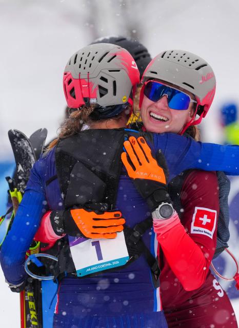 (260219) -- BORMIO, Feb. 19, 2026 (Xinhua) -- Gold medalist Marianne Fatton (R) of Switzerland hugs Emily Harrop of France after the ski mountaineering women's sprint event at the Milan-Cortina 2026 Olympic Winter Games in Bormio, Italy, Feb. 19, 2026. (Xinhua/Yan Linyun)