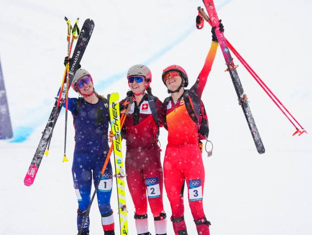 (260219) -- BORMIO, Feb. 19, 2026 (Xinhua) -- Gold medalist Marianne Fatton (C) of Switzerland, silver medalist Emily Harrop (L) of France, and bronze medalist Ana Alonso Rodriguez of Spain celebrate after the ski mountaineering women's sprint event at the Milan-Cortina 2026 Olympic Winter Games in Bormio, Italy, Feb. 19, 2026. (Xinhua/Yan Linyun)