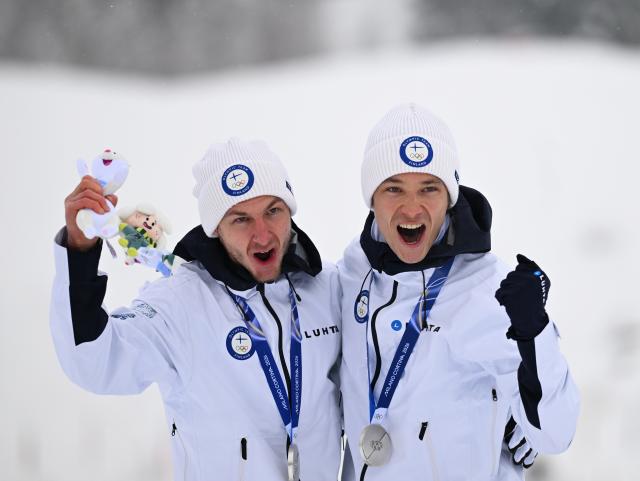 (260219) -- TESERO, Feb. 19, 2026 (Xinhua) -- Silver medalists Ilkka Herola and Eero Hirvonen of Finland pose for photos during the awarding ceremony of the nordic combined team sprint at the 2026 Milan-Cortina Winter Olympics in Tesero, Italy, Feb. 19, 2026. (Xinhua/He Canling)
