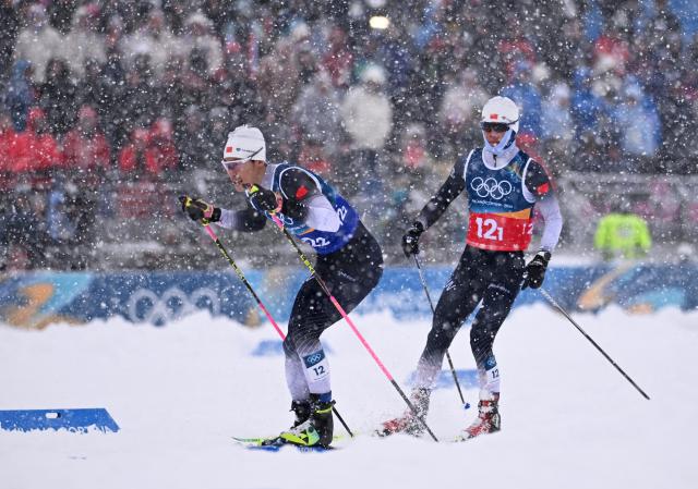 (260219) -- TESERO, Feb. 19, 2026 (Xinhua) -- Zhao Zihe (R) and Zhao Jiawen of China compete during the cross-country event of the nordic combined team sprint at the 2026 Milan-Cortina Winter Olympics in Tesero, Italy, Feb. 19, 2026. (Xinhua/He Canling)