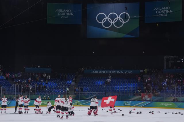 (260219) -- MILAN, Feb. 19, 2026 (Xinhua) -- Players of Switzerland celebrate after winning the ice hockey women's bronze medal game between Switzerland and Sweden at the Milan-Cortina 2026 Olympic Winter Games in Milan, Italy, Feb. 19, 2026. (Xinhua/Tao Xiyi)