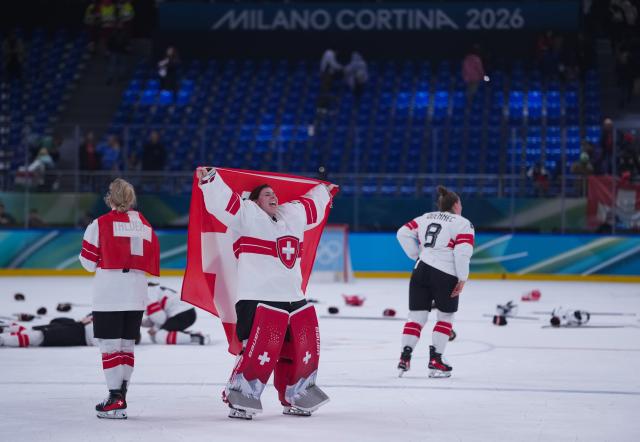 (260219) -- MILAN, Feb. 19, 2026 (Xinhua) -- Goalkeeper Andrea Braendli (C) of Switzerland celebrates after the ice hockey women's bronze medal game between Switzerland and Sweden at the Milan-Cortina 2026 Olympic Winter Games in Milan, Italy, Feb. 19, 2026. (Xinhua/Tao Xiyi)