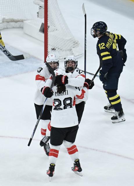 (260219) -- MILAN, Feb. 19, 2026 (Xinhua) -- Players of Switzerland celebrate scoring during the ice hockey women's bronze medal game between Switzerland and Sweden at the Milan-Cortina 2026 Olympic Winter Games in Milan, Italy, Feb. 19, 2026. (Xinhua/Zhang Haofu)