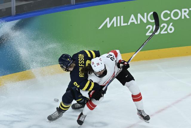 (260219) -- MILAN, Feb. 19, 2026 (Xinhua) -- Jessica Adolfsson (L) of Sweden vies with Sinja Leemann of Switzerland during the ice hockey women's bronze medal game between Switzerland and Sweden at the Milan-Cortina 2026 Olympic Winter Games in Milan, Italy, Feb. 19, 2026. (Xinhua/Zhang Haofu)