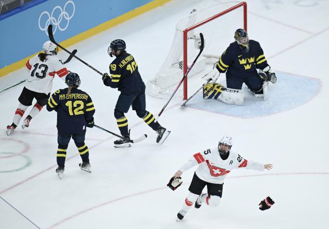 (260219) -- MILAN, Feb. 19, 2026 (Xinhua) -- Alina Muller (bottom) of Switzerland celebrates scoring during the ice hockey women's bronze medal game between Switzerland and Sweden at the Milan-Cortina 2026 Olympic Winter Games in Milan, Italy, Feb. 19, 2026. (Xinhua/Zhang Haofu)