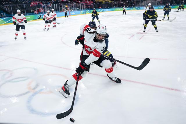 (260219) -- MILAN, Feb. 19, 2026 (Xinhua) -- Nicole Vallario (front) of Switzerland competes during the ice hockey women's bronze medal game between Switzerland and Sweden at the Milan-Cortina 2026 Olympic Winter Games in Milan, Italy, Feb. 19, 2026. (Xinhua/Wang Kaiyan)