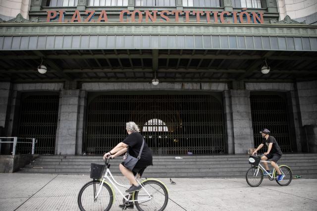 (260219) -- BUENOS AIRES, Feb. 19, 2026 (Xinhua) -- Cyclists pass by one of the entrances of a closed train station, in Buenos Aires, Argentina, on Feb. 19, 2026. Argentina's main labor unions started a nationwide 24-hour strike on Thursday in protest against a labor reform bill under debate in the Chamber of Deputies, after it was approved by the Senate on Feb. 12. (Photo by Martin Zabala/Xinhua)