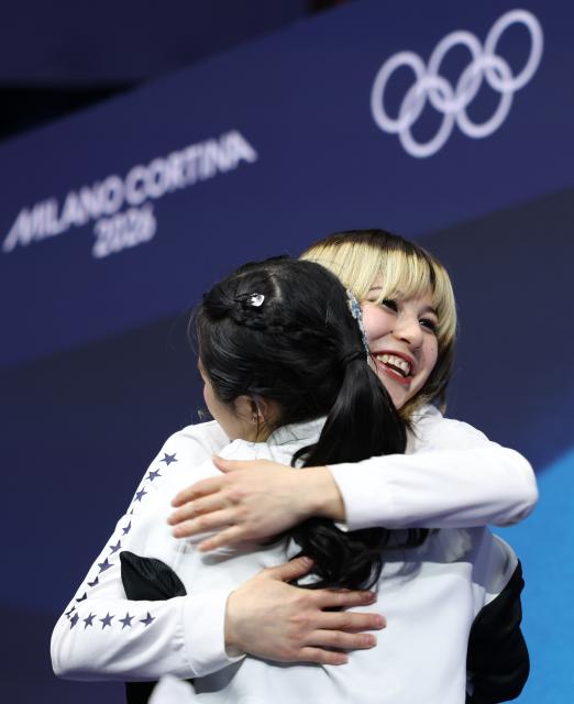 (260219) -- MILAN, Feb. 19, 2026 (Xinhua) -- Alysa Liu (back) of the United States hugs Nakai Ami of Japan after the free skating match of figure skating women single skating at the Milan-Cortina 2026 Olympic Winter Games in Milan, Italy, Feb. 19, 2026. (Xinhua/Li Ming)