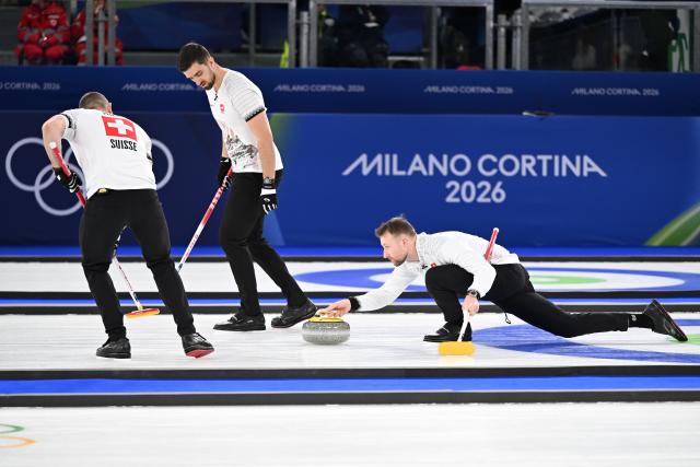 (260220) -- CORTINA D'AMPEZZO, Feb. 20, 2026 (Xinhua) -- Yannick Schwaller (R) of Switzerland competes during the curling men's semi-final match between Britain and Switzerland at the 2026 Milan-Cortina Winter Olympics in Cortina, Italy, Feb. 19, 2026. (Xinhua/Lian Yi)
