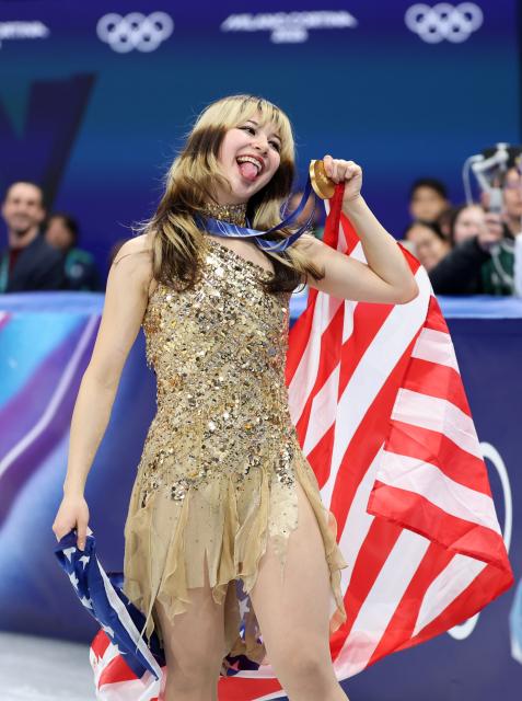 (260220) -- MILAN, Feb. 20, 2026 (Xinhua) -- Gold medalist Alysa Liu of the United States poses for photos with the medal after the awarding ceremony of the figure skating women single skating event at the Milan-Cortina 2026 Olympic Winter Games in Milan, Italy, Feb. 19, 2026. (Xinhua/Li Ming)