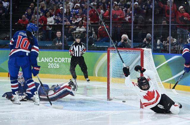 (260220) -- MILAN, Feb. 20, 2026 (Xinhua) -- Kristin O'neill (1st R) of Canada scores during the ice hockey women's gold medal game between the United States and Canada at the Milan-Cortina 2026 Olympic Winter Games in Milan, Italy, Feb. 19, 2026. (Xinhua/Zhang Haofu)