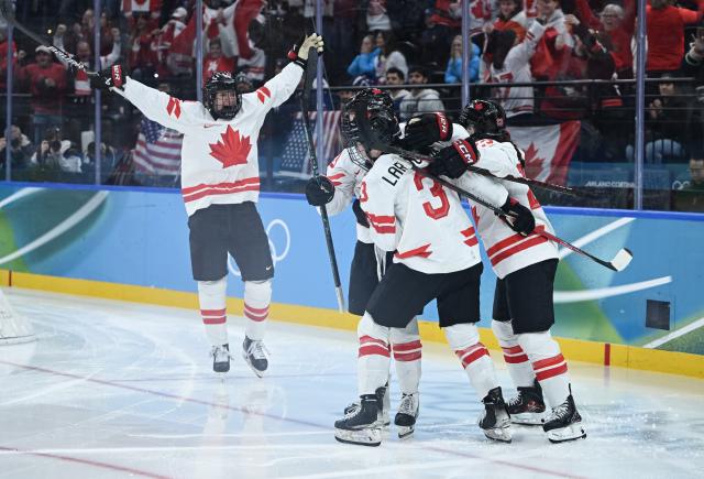 (260220) -- MILAN, Feb. 20, 2026 (Xinhua) -- Players of Canada celebrate a goal during the ice hockey women's gold medal game between the United States and Canada at the Milan-Cortina 2026 Olympic Winter Games in Milan, Italy, Feb. 19, 2026. (Xinhua/Zhang Haofu)