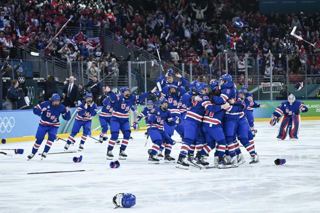 (260220) -- MILAN, Feb. 20, 2026 (Xinhua) -- Players of the United States celebrate victory after the ice hockey women's gold medal game between the United States and Canada at the Milan-Cortina 2026 Olympic Winter Games in Milan, Italy, Feb. 19, 2026. (Xinhua/Zhang Haofu)