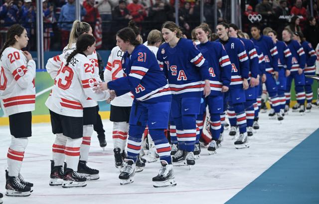 (260220) -- MILAN, Feb. 20, 2026 (Xinhua) -- Players of both teams shake hands after the ice hockey women's gold medal game between the United States and Canada at the Milan-Cortina 2026 Olympic Winter Games in Milan, Italy, Feb. 19, 2026. (Xinhua/Zhang Haofu)