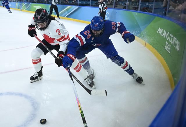 (260220) -- MILAN, Feb. 20, 2026 (Xinhua) -- Joy Dunne (R) of the United States vies with Jocelyne Larocque of Canada during the ice hockey women's gold medal game between the United States and Canada at the Milan-Cortina 2026 Olympic Winter Games in Milan, Italy, Feb. 19, 2026. (Xinhua/Zhang Haofu)