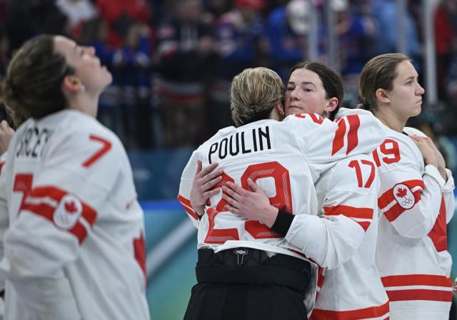 (260220) -- MILAN, Feb. 20, 2026 (Xinhua) -- Ella Shelton (2nd R) and Marie-Philip Poulin (2nd L) of Canada hug after the ice hockey women's gold medal game between the United States and Canada at the Milan-Cortina 2026 Olympic Winter Games in Milan, Italy, Feb. 19, 2026. (Xinhua/Zhang Haofu)
