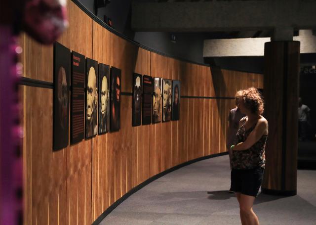 (260220) -- GAUTENG, Feb. 20, 2026 (Xinhua) -- Visitors look at the posters at the Maropeng exhibition center, located in the Cradle of Humankind World Heritage Site, in Gauteng Province, South Africa, on Feb. 19, 2026. The World Heritage listed Cradle of Humankind caves have produced a rich collection of human ancestor fossils. (Xinhua/Chen Wei)