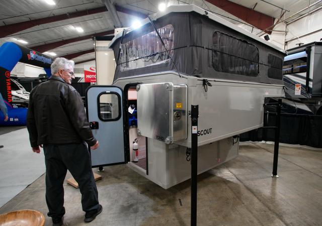 (260220) -- ABBOTSFORD, Feb. 20, 2026 (Xinhua) -- A man looks at a pop-up camper at the 2026 Earlybird RV (recreational vehicles) Show & Sale in Abbotsford, British Columbia, Canada, on Feb. 19, 2026. The four-day event kicked off here on Thursday. (Photo by Liang Sen/Xinhua)