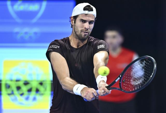 (260220) -- DOHA, Feb. 20, 2026 (Xinhua) -- Karen Khachanov of Russia hits a return during the men's singles quarterfinal match between Carlos Alcaraz of Spain and Karen Khachanov of Russia at the ATP Qatar Open 2026 tennis tournament in Doha, Qatar, Feb. 19, 2026. (Photo by Nikku/Xinhua)