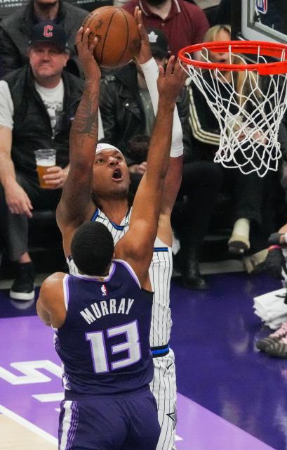 (260220) -- SACRAMENTO, Feb. 20, 2026 (Xinhua) -- Paolo Banchero (back) of Orlando Magic dunks during the 2025-2026 NBA regular season basketball game between Sacramento Kings and Orlando Magic in Sacramento, the United States, Feb. 19, 2026. (Photo by Sun Yuxuan/Xinhua)