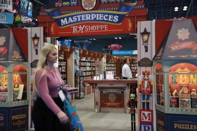 (260220) -- NEW YORK, Feb. 20, 2026 (Xinhua) -- A visitor walks past the booth of MasterPieces Inc. at Toy Fair 2026 in New York City, the United States, on Feb. 17, 2026. TO GO WITH "Feature: Tariff hikes continue to bite into U.S. toy industry, consumers" (Xinhua/Liu Yanan)