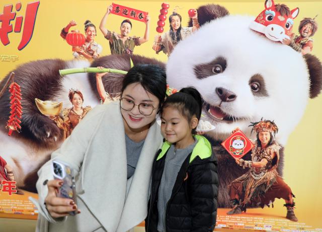 (260220) -- BEIJING, Feb. 20, 2026 (Xinhua) -- Audiences take a selfie in front of a movie poster at a cinema in Boxing County of Binzhou City, east China's Shandong Province, Feb. 20, 2026. China's Ministry of Culture and Tourism launched a month-long cultural and tourism campaign ahead of the Spring Festival, featuring a wide range of activities and promotional measures to better meet people's needs.
   Running from late January to early March, the campaign will see about 30,000 activities held nationwide, offering seasonal cultural and tourism products and events focused on traditional New Year customs, performances, and exhibitions.
   More than 360 million yuan (about 51.6 million U.S. dollars) in consumption vouchers and subsidies will be distributed, alongside measures such as ticket discounts, bundled ticket incentives, and cross-regional tourism promotions. (Photo by Chen Bin/Xinhua)