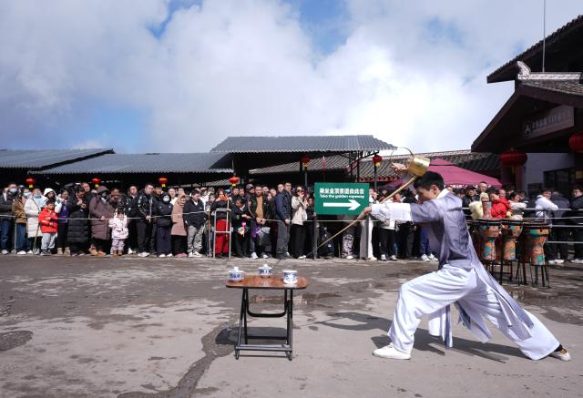 (260220) -- BEIJING, Feb. 20, 2026 (Xinhua) -- People watch a tea art performance while waiting to take the ropeway at the scenic area of Mount Emei in southwest China's Sichuan Province, Feb. 20, 2026. China's Ministry of Culture and Tourism launched a month-long cultural and tourism campaign ahead of the Spring Festival, featuring a wide range of activities and promotional measures to better meet people's needs.
   Running from late January to early March, the campaign will see about 30,000 activities held nationwide, offering seasonal cultural and tourism products and events focused on traditional New Year customs, performances, and exhibitions.
   More than 360 million yuan (about 51.6 million U.S. dollars) in consumption vouchers and subsidies will be distributed, alongside measures such as ticket discounts, bundled ticket incentives, and cross-regional tourism promotions. (Xinhua/Jiang Hongjing)