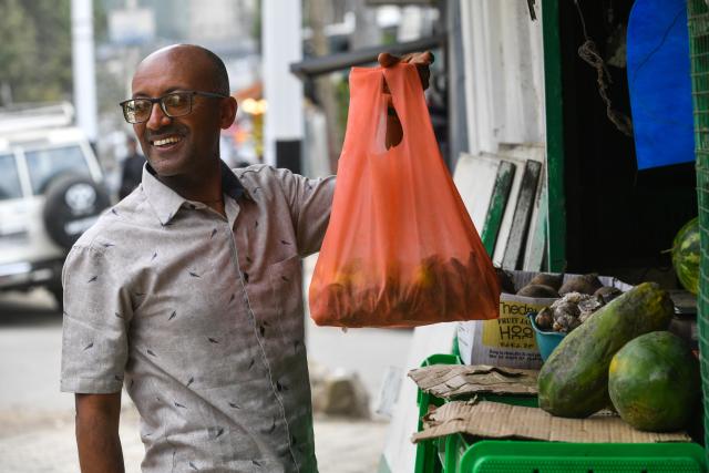 (260220) -- ADDIS ABABA, Feb. 20, 2026 (Xinhua) -- A man uses a woven bag on a street in Addis Ababa, Ethiopia, Feb. 7, 2026. TO GO WITH "Feature: Ethiopia embraces paper bags as single-use plastic ban takes effect" (Photo by Michael Tewelde/Xinhua)