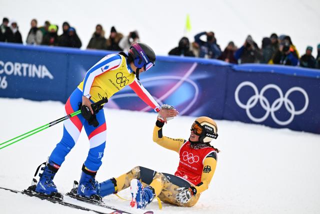 (260220) -- LIVIGNO, Feb. 20, 2026 (Xinhua) -- Daniela Maier (R) of Germany interacts with Marielle Berger Sabbatel of France after the big final of the freestyle skiing women's ski cross event at the Milan-Cortina 2026 Olympic Winter Games in Livigno, Italy, Feb. 20, 2026. (Xinhua/Zhang Hongxiang)