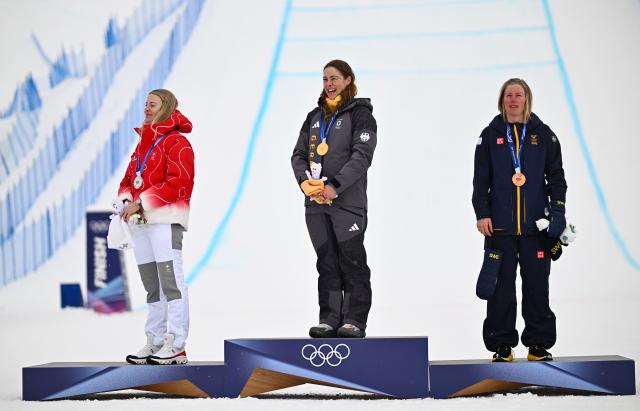 (260220) -- LIVIGNO, Feb. 20, 2026 (Xinhua) -- Gold medalist Daniela Maier (C) of Germany, silver medalist Fanny Smith (L) of Switzerland, and bronze medalist Sandra Naeslund of Sweden attend the awarding ceremony of the freestyle skiing women's ski cross event at the Milan-Cortina 2026 Olympic Winter Games in Livigno, Italy, Feb. 20, 2026. (Xinhua/Zhang Hongxiang)