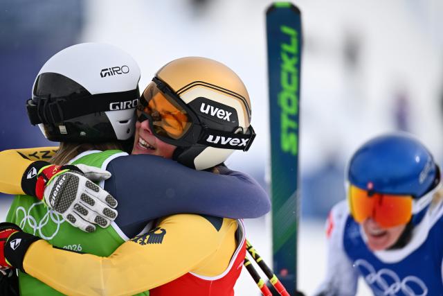 (260220) -- LIVIGNO, Feb. 20, 2026 (Xinhua) -- Daniela Maier (C) of Germany hugs Sandra Naeslund of Sweden after the big final of the freestyle skiing women's ski cross event at the Milan-Cortina 2026 Olympic Winter Games in Livigno, Italy, Feb. 20, 2026. (Xinhua/Zhang Hongxiang)