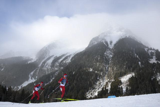 (260220) -- ANTERSELVA, Feb. 20, 2026 (Xinhua) -- Joscha Burkhalter (R) of Switzerland competes during the biathlon men's 15km mass start event at the 2026 Milan-Cortina Winter Olympics in Anterselva, Italy, Feb. 20, 2026. (Xinhua/Zhang Tao)