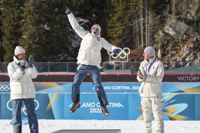 (260220) -- ANTERSELVA, Feb. 20, 2026 (Xinhua) -- Gold medalist Johannes Dale-Skjevdal (C) of Norway celebrates during the awarding ceremony of the biathlon men's 15km mass start event at the 2026 Milan-Cortina Winter Olympics in Anterselva, Italy, Feb. 20, 2026. (Xinhua/Zhang Tao)