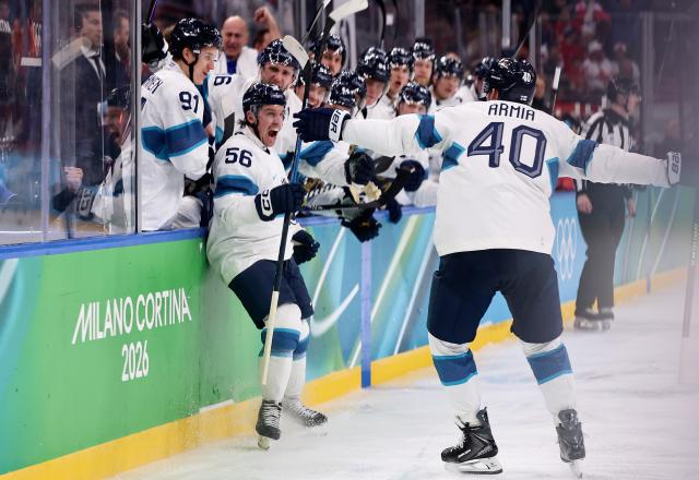 (260220) -- MILAN, Feb. 20, 2026 (Xinhua) -- Players of Finland celebrate scoring during the ice hockey men's play-offs quarterfinal between Canada and Finland at the Milan-Cortina 2026 Olympic Winter Games in Milan, Italy, Feb. 20, 2026. (Xinhua/Wang Kaiyan)