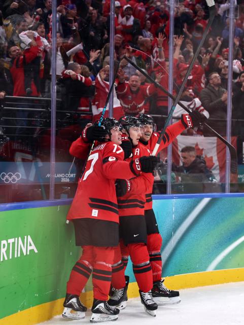(260220) -- MILAN, Feb. 20, 2026 (Xinhua) -- Players of Canada celebrate scoring during the ice hockey men's play-offs semifinal match between Canada and Finland at the Milan-Cortina 2026 Olympic Winter Games in Milan, Italy, Feb. 20, 2026. (Xinhua/Wang Kaiyan)
