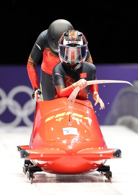 (260220) -- CORTINA D'AMPEZZO, Feb. 20, 2026 (Xinhua) -- Huai Mingming/Wang Xuan of China compete during the Bobsleigh 2-woman heat 1 at the 2026 Milan-Cortina Winter Olympics in Cortina D'Ampezzo, Italy, Feb. 20, 2026. (Xinhua/Ding Xu)