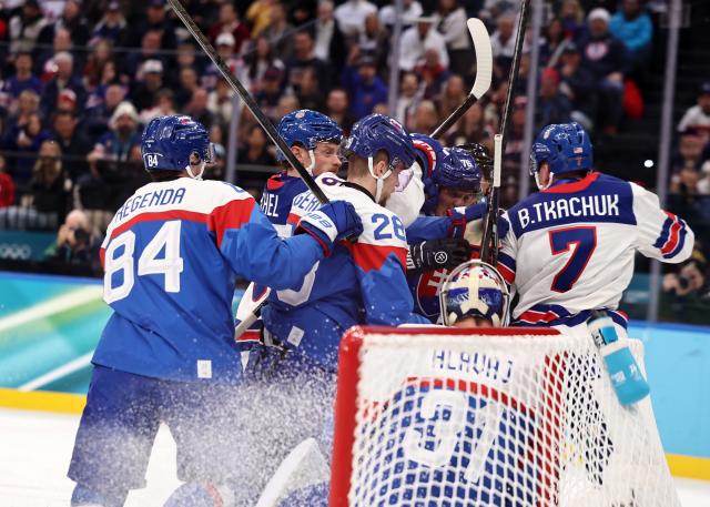 (260221) -- MILAN, Feb. 21, 2026 (Xinhua) -- Players of both teams fight during the ice hockey men's play-offs semifinal match between the United States and Slovakia at the Milan-Cortina 2026 Olympic Winter Games in Milan, Italy, Feb. 20, 2026. (Xinhua/Wang Kaiyan)