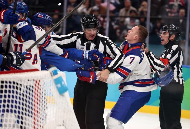 (260221) -- MILAN, Feb. 21, 2026 (Xinhua) -- Brady Tkachuk (2nd R) of the United States fights with players of Slovakia during the ice hockey men's play-offs semifinal match between the United States and Slovakia at the Milan-Cortina 2026 Olympic Winter Games in Milan, Italy, Feb. 20, 2026. (Xinhua/Wang Kaiyan)