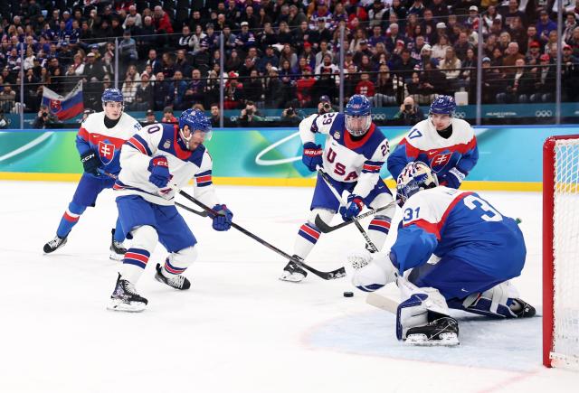 (260221) -- MILAN, Feb. 21, 2026 (Xinhua) -- JT Miller (2nd L) of the Unites States shoots during the ice hockey men's play-offs semifinal match between the United States and Slovakia at the Milan-Cortina 2026 Olympic Winter Games in Milan, Italy, Feb. 20, 2026. (Xinhua/Wang Kaiyan)