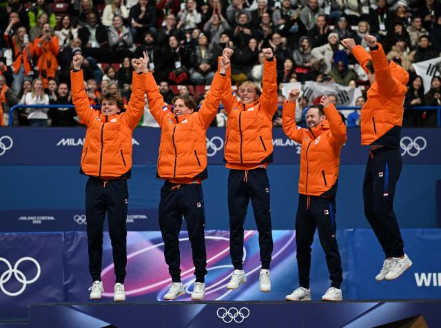(260221) -- MILAN, Feb. 21, 2026 (Xinhua) -- Gold medalists from the Netherlands celebrate during the awarding ceremony of the short track speed skating men's 5000m relay at the Milan-Cortina 2026 Olympic Winter Games in Milan, Italy, Feb. 20, 2026. (Xinhua/Cheng Min)